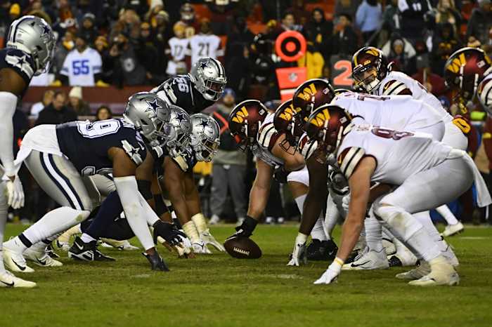 Washington Commanders and Dallas Cowboys at the line of scrimmage during the second half at FedExField.